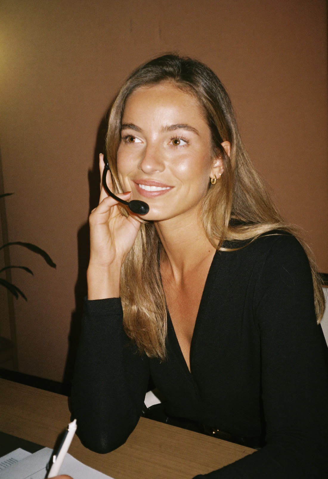 Jade advisor smiling on a call at her desk