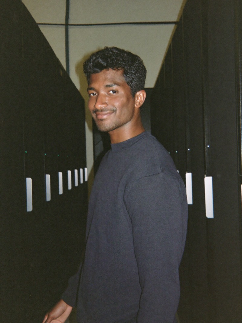 Data center founder in an aisle of server racks